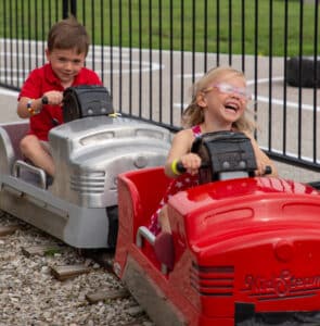 handcar hand car two kids girl laughing girl and boy girl with glasses
